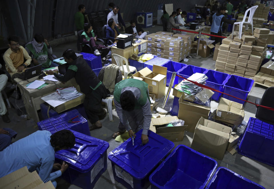 In this Monday, Oct. 15, 2018 photo, election workers secure ballot boxes ahead of parliamentary elections, in Kabul, Afghanistan. The elections are being held Saturday despite deep security concerns and ongoing fighting in as many as 20 out of the country’s 34 provinces. The vote comes amid a particularly vicious campaign by the Taliban and the Islamic State group, which have been staging near-daily attacks and there have also been concerns over the transparency of the vote. (AP Photo/Rahmat Gul)