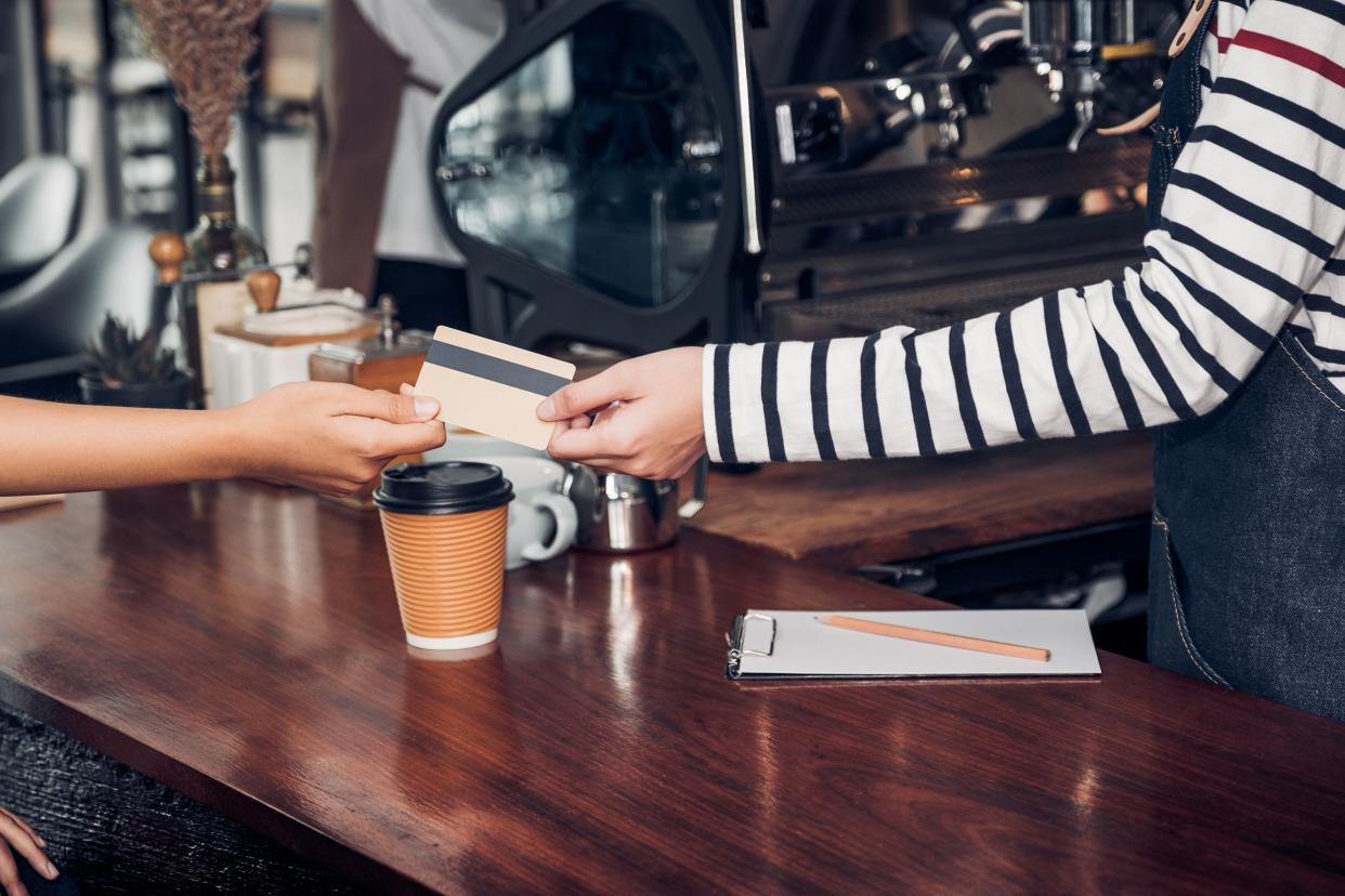 customer pay coffee drink with credit card to barista