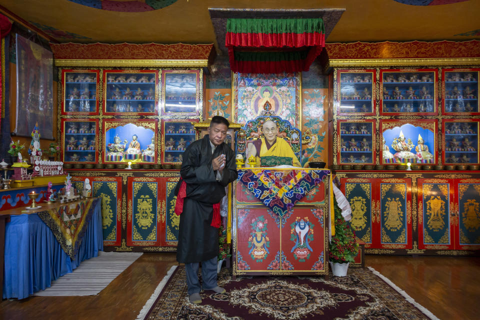 Penpa Tsering, the newly elected President of the Central Tibetan Administration, poses for a photograph next to a portrait of his spiritual leader the Dalai Lama in Dharmsala, India, Thursday, May 27, 2021. The new president of the Tibetan exile government said Thursday he was willing to reach out to the Chinese government to resolve their conflict, though the sides haven't had dialogue in the past decade. (AP Photo/Ashwini Bhatia)