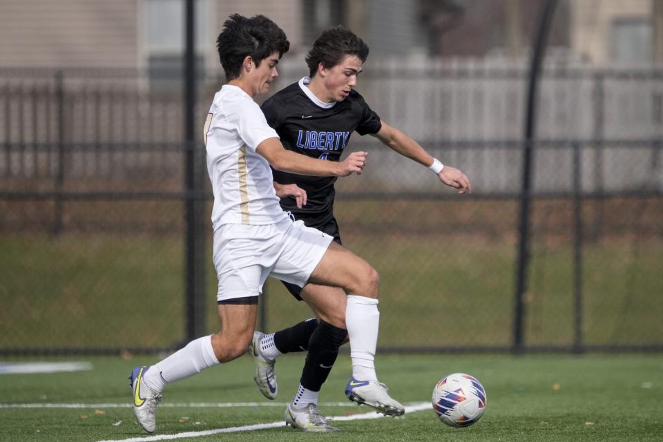 New Albany’s Luke Haffer (front) battles Olentangy Liberty’s Will Hornbaker during the Division I regional final Nov. 5 at Marysville.