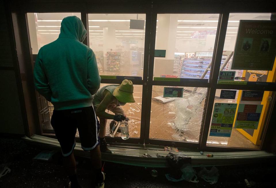 Bottles of alcohol are stolen from the Rite Aid at 827 K Street in downtown Sacramento in May 2020, after a protest about the killing of George Floyd by Minneapolis police officers.