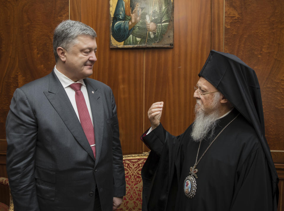 FILE - In this April 9, 2018 file photo, Ecumenical Orthodox Patriarch Bartholomew I, right, speaks with Ukrainian President Petro Poroshenko in Istanbul, Turkey. Poroshenko visited in an effort to convince the patriarch to agree to a split, which he has described as “a matter of our independence and our national security.” Moscow’s Patriarch Kirill is planning to fly to Turkey in late August 2018 in a last-ditch bid to prevent it. (Mikhail Palinchak/Presidential Press Service Pool Photo via AP, File)