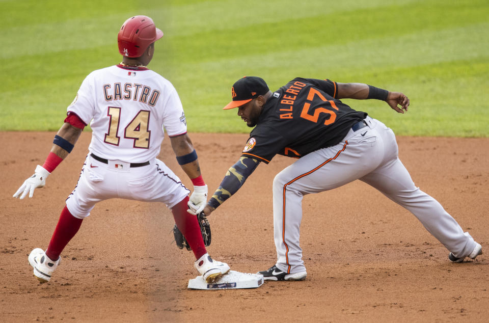 Washington Nationals' Starlin Castro (14) beats the tag of Baltimore Orioles second baseman Hanser Alberto (57) during the first inning of a baseball game in Washington, Friday, Aug. 7, 2020. (AP Photo/Manuel Balce Ceneta)