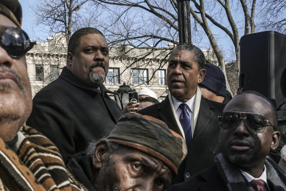 Manhattan District Attorney Alvin Bragg, second from left, and U.S. Rep. Adriano Espaillat, D-N.Y., attend a ceremony to name the northeast gateway of Central Park as "The Gate of the Exonerated," for five men, including Yusef Salaam, seated far right, exonerated after being wrongfully convicted as teenagers for the 1989 rape of a jogger in Central Park, Monday Dec. 19, 2022, in New York. The entrance was named to honor Salaam, Raymond Santana Jr., Kevin Richardson, Antron McCray and Korey Wise, who were exonerated in the case. (AP Photo/Bebeto Matthews)