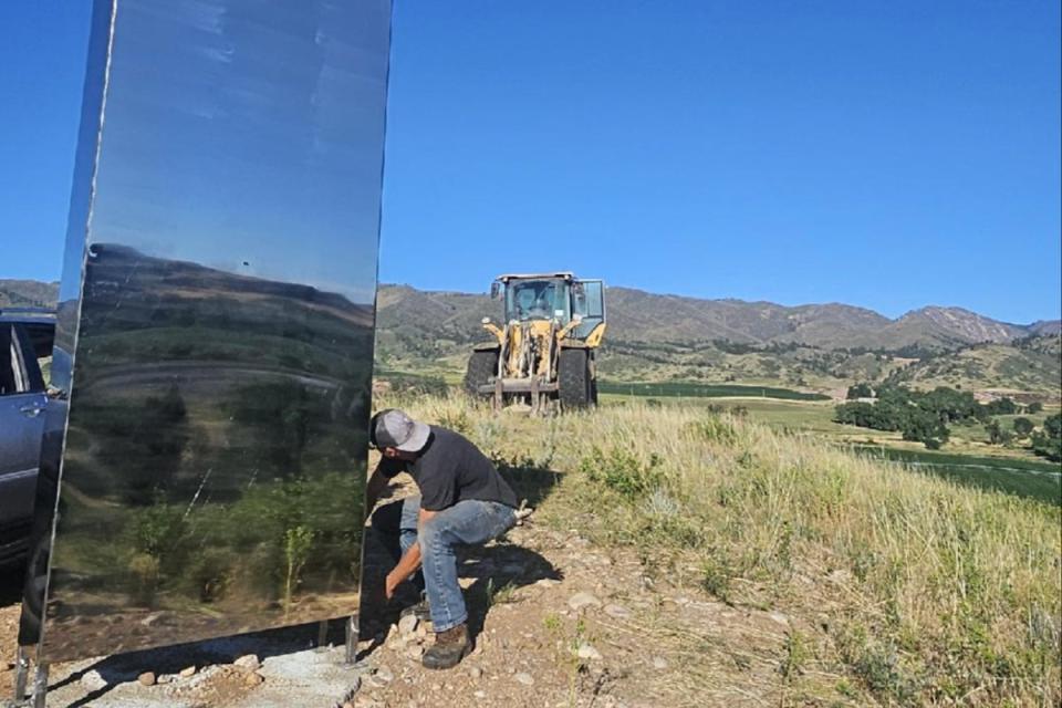 Pictures showed the tall, shiny, rectangular object being unbolted by workers and removed with a tractor and forklift (Morning Fresh Dairy Farm/ Facebook)