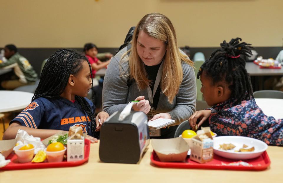 IndyStar K-12 education reporter Caroline Beck talks to students during lunchtime at Circle City Prep on Dec. 6, 2023.