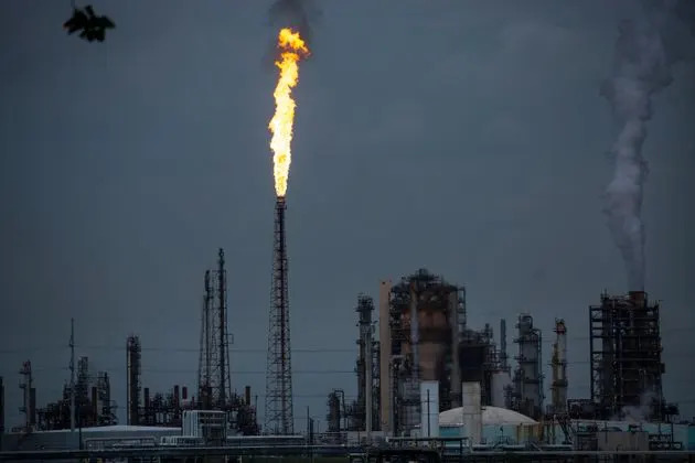 A gas flare from a Shell Chemical LP petroleum refinery illuminates the sky in Norco, Louisiana.