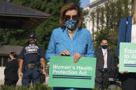 With Capitol Police standing near, House Speaker Nancy Pelosi, D-Calif., waits to talk to reporters before a House vote on legislation aimed at guaranteeing a woman’s right to an abortion, an effort by House Democrats to circumvent a new Texas law that has placed that access under threat, at the Capitol in Washington, Friday, Sept. 24, 2021. (AP Photo/J. Scott Applewhite)