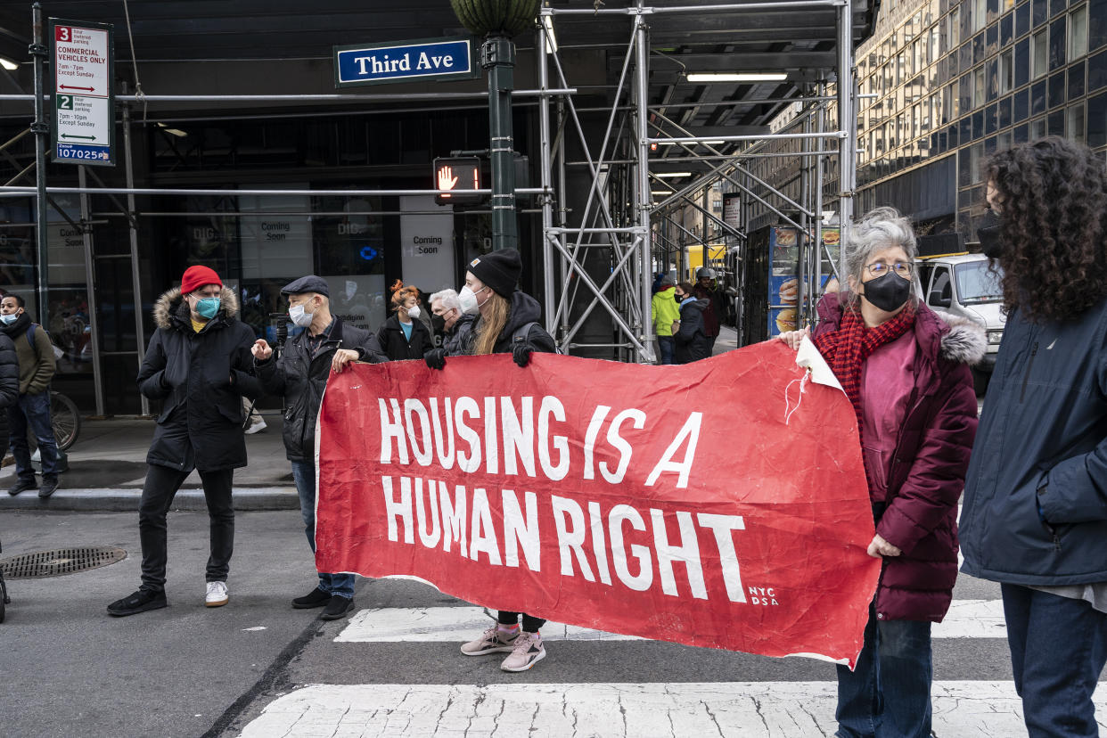 Protesters hold a banner saying: Housing Is a Human Right.