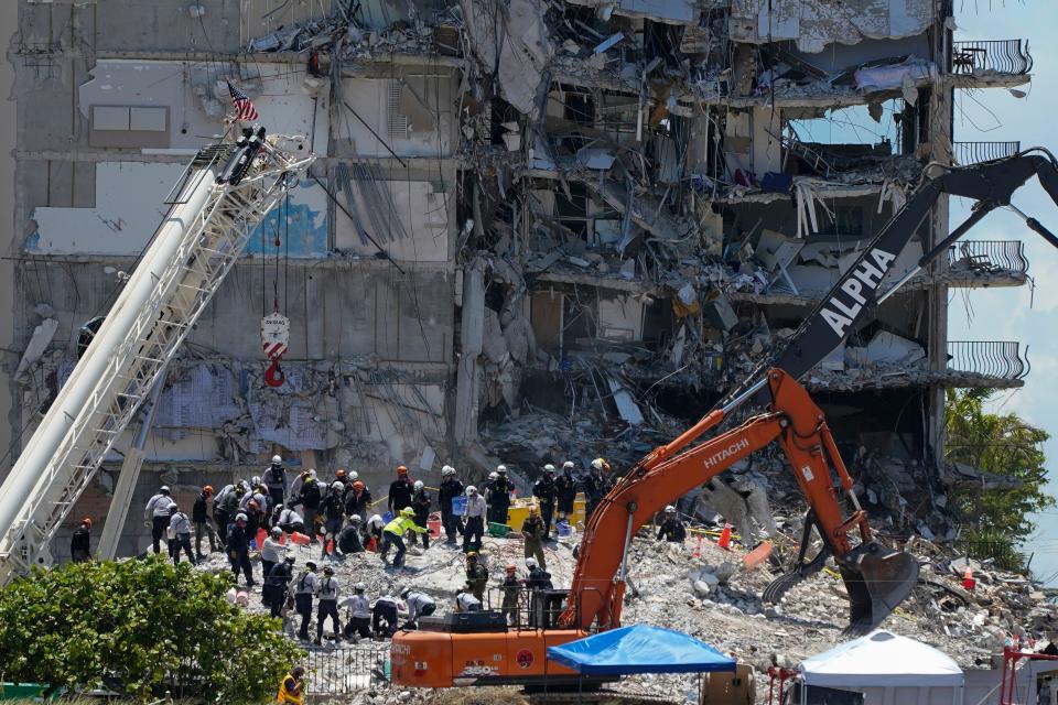 Search and rescue personnel work atop the rubble at the Champlain Towers South condo building, where scores of victims remain missing more than a week after it partially collapsed, Friday, July 2, 2021, in Surfside, Fla.