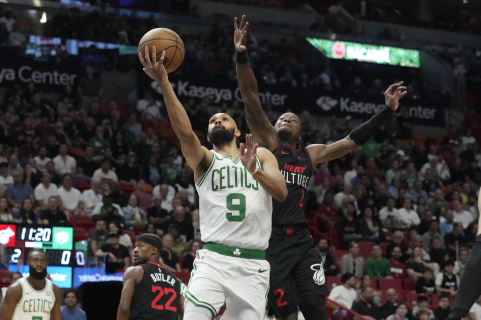 Boston Celtics guard Derrick White (9) doves to the basket as Miami Heat guard Terry Rozier (2) defends during the first half of an NBA basketball game, Thursday, Jan. 25, 2024, in Miami. (AP Photo/Marta Lavandier)