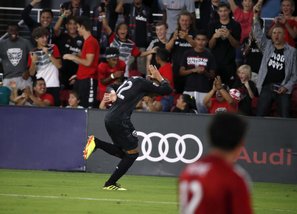 D.C. United midfielder Yamil Asad (22) celebrates his goal past Vancouver Whitecaps goalkeeper Brian Rowe (12) during the first half of an MLS soccer match at Audi Field, Saturday, July 14, 2018, in Washington. (AP Photo/Alex Brandon)