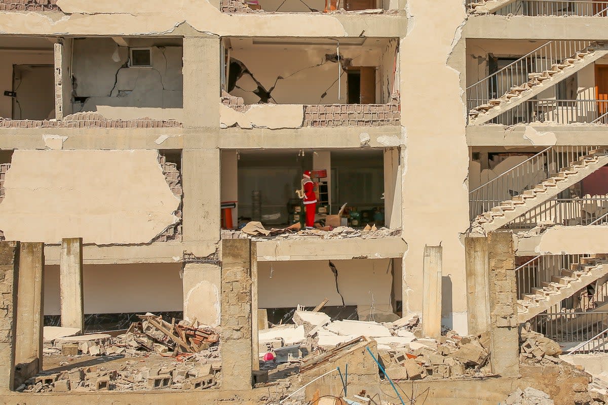 A mannequin dressed as Santa Claus stands inside an apartment of a destroyed building following the earthquake in Samandag (AP)