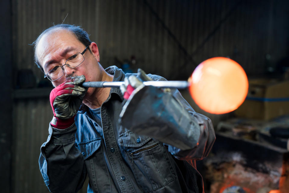 someone blowing glass