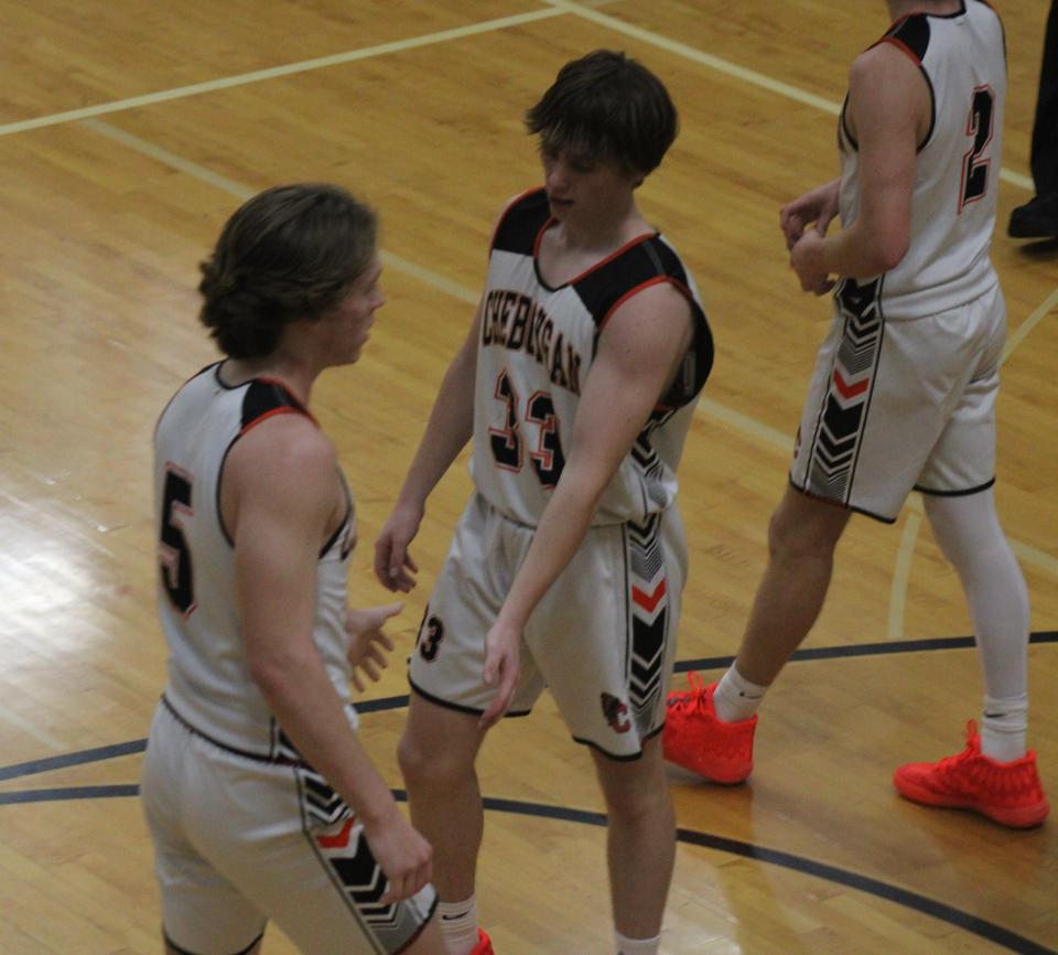Cheboygan junior Ethan Gibbons (33) gets congratulated by fellow junior Caden Gardner (5) after Gibbons scored a basket and was fouled during the first half against Grayling on Wednesday.