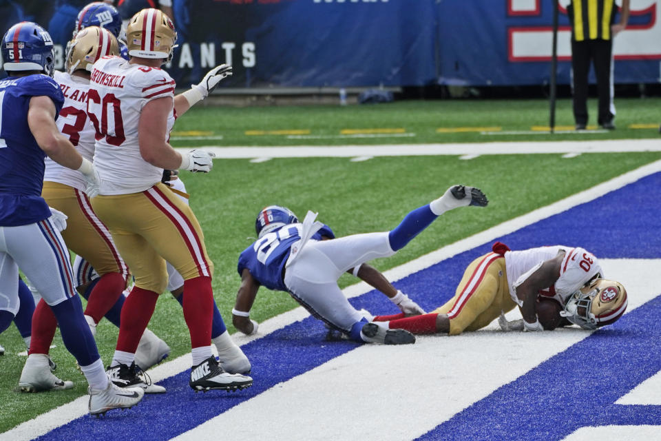 San Francisco 49ers' Jeff Wilson, right, scores a touchdown during the second half of an NFL football game against the New York Giants, Sunday, Sept. 27, 2020, in East Rutherford, N.J. (AP Photo/Corey Sipkin)
