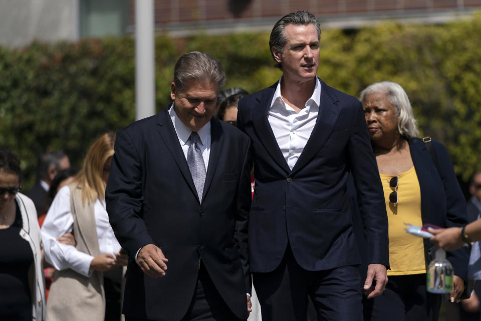 California Gov. Gavin Newsom, right, and state Sen. Bob Hertzberg arrive for a news conference held on the campus of Santa Monica College in Santa Monica, Calif., Friday, July 22, 2022. Newsom signed a gun control law Friday, a month after conservative justices overturned women's constitutional right to abortions and undermined gun control laws in states including California. (AP Photo/Jae C. Hong)