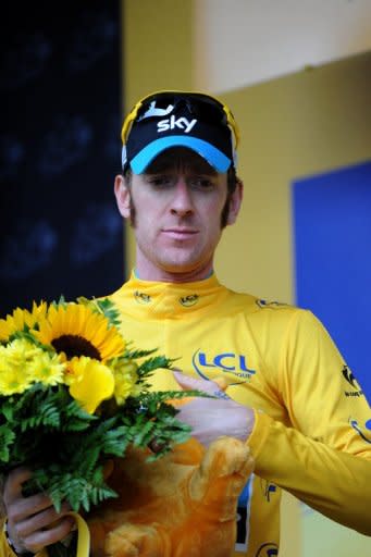 Overall leader's yellow jersey, British Bradley Wiggins, celebrates on the podium at the end of the 191 km and fourteenth stage of the 2012 Tour de France cycling race starting in Limoux and finishing in Foix, southern France