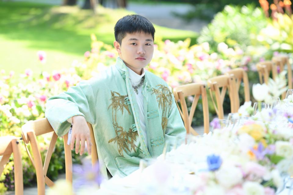 Yu Zheng, founder of Fashionmodels, wearing an embroidered Chinese style jacket by M Essential. - Credit: Courtesy