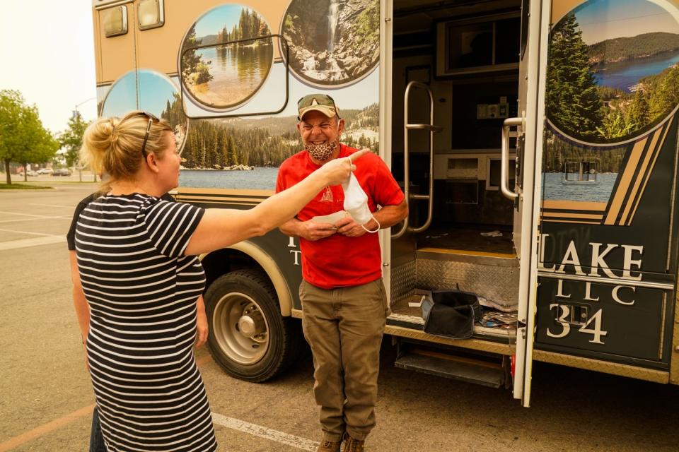 Niles Kant greets Karin Farley as she tells him that she has the spare key for the truck behind him.