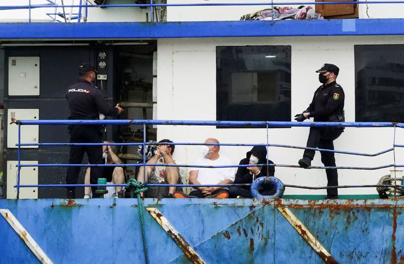 Police officers guard four detainees on the fishing boat "AKT-1", in the island of Gran Canaria