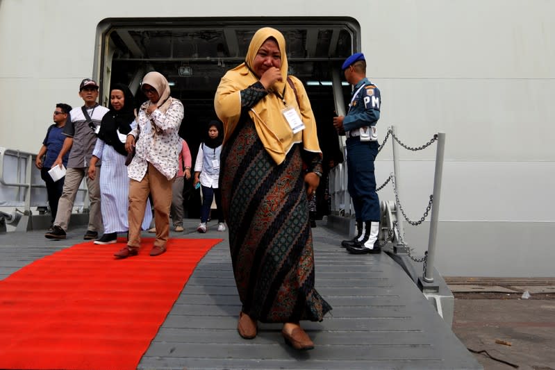 Relative of passenger who died on Lion Air JT-610 crash at the Java sea, cries as she arrives at Jakarta International Port after attending commemoration of a year of the crash in Jakarta