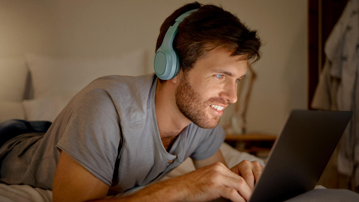  Man listening to music on his laptop. 
