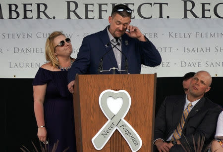 Sean Graves, shot six times in the Columbine high school shooting, sheds a tear with his wife Kara at his side at a ceremony to commemorate the 20th anniversary of the attack in Littleton, Colorado, U.S., April 20, 2019. Graves was paralyzed from the neck down but after dozens of surgeries can now walk. REUTERS/Rick Wilking