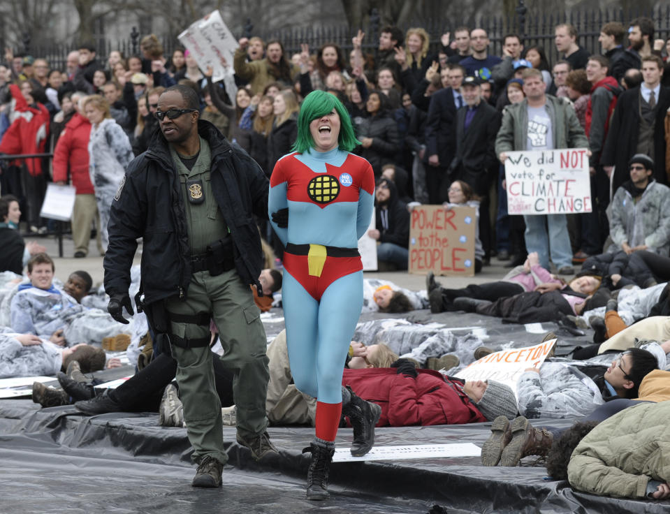 Several hundred students and youth who marched from Georgetown University to the White House to protest the Keystone XL Pipeline are arrested outside the White House in Washington, Sunday, March 2, 2014. (AP Photo/Susan Walsh)