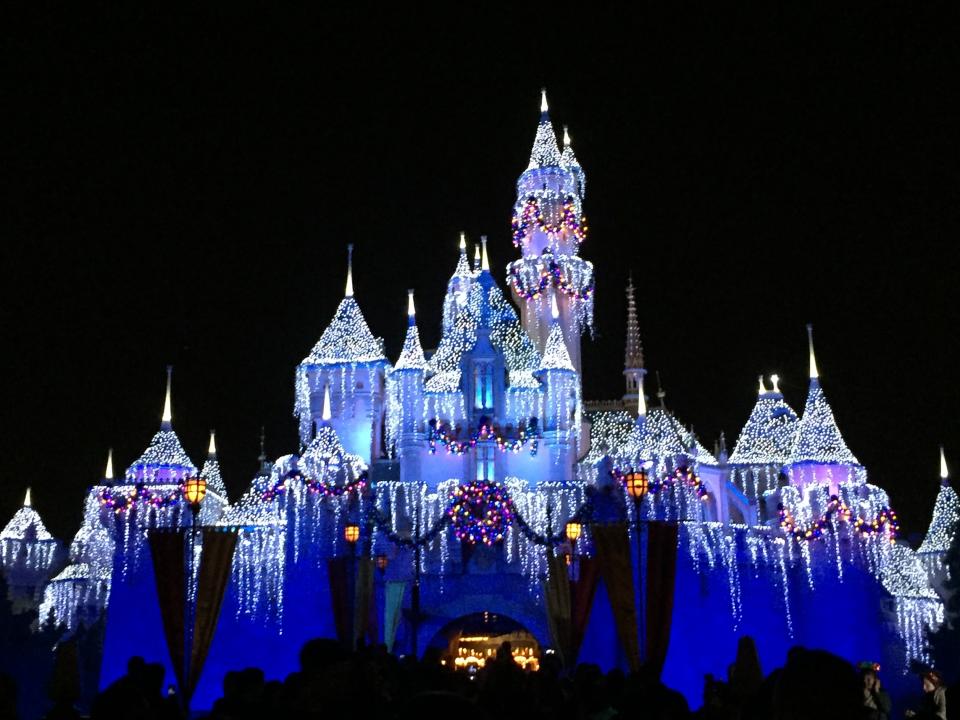 Disneyland's Sleeping Beauty Castle lit up on a winter night.