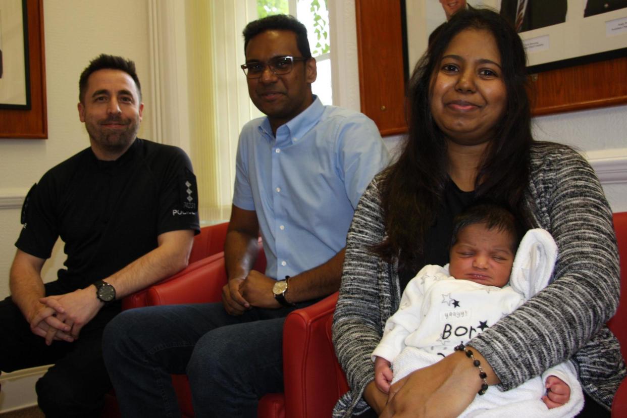 Baby Abiman with his mother and father and one of the officers: Essex Police