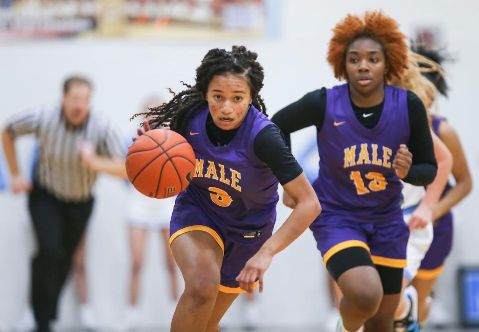 Male's Makya Grinter drives towards the basket after stealing the ball from Mercy's Mary Reagan Smith Wednesday night. Grinter had four steals in the game. Dec.1, 2021 