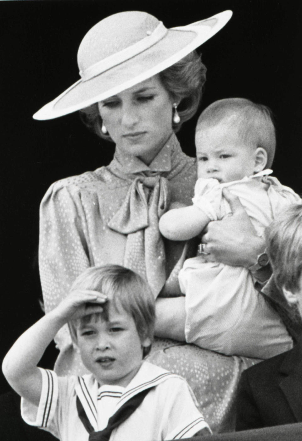 Prince William is seen making a royal salute as he watches the scene of Trooping the Colour from the balcony of Buckingham Palace with his brother Harry and mother Princess Diana in London in this June 15, 1985 file photograph. REUTERS/Roy Letkey/Files