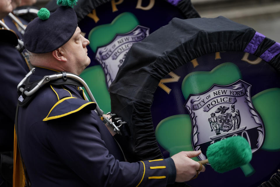 A percussionist with the NYPD Emerald Society Pipes and Drums band marches outside St. Patrick's Cathedral for Officer Wilbert Mora's funeral, Wednesday, Feb. 2, 2022, in New York. For the second time in under a week, police converged on New York City's St. Patrick's Cathedral to pay tribute to a young officer gunned down while answering a call for help in Harlem. Mora was shot along with Officer Jason Rivera on Jan. 22 while responding to a call about a domestic argument in an apartment. (AP Photo/John Minchillo)