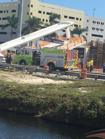 Emergency crews respond to the scene of a collapsed pedestrian bridge at Florida International University in Miami, Florida, U.S., March 15, 2018 in this image obtain from social media. Instagram/ @barbituriinsua via REUTERS