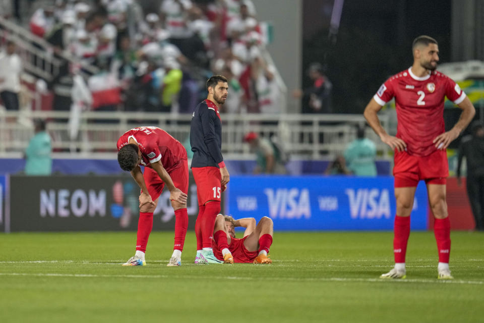 Syria players react after Iran's Ehsan Hajisafi scoring the winning penalty in a penalty shootout at the end of the Asian Cup Round of 16 soccer match between Iran and Syria, at Abdullah Bin Khalifa Stadium in Doha, Qatar, Wednesday, Jan. 31, 2024. (AP Photo/Aijaz Rahi)