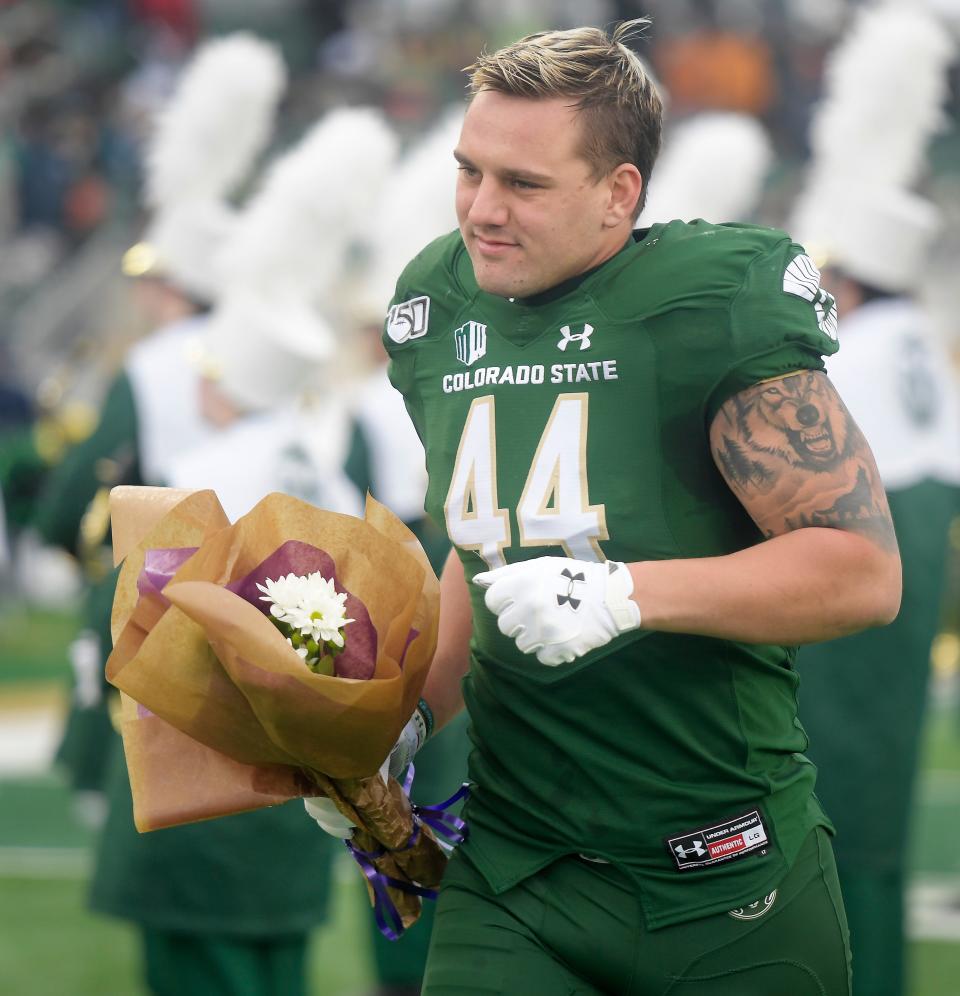 Colorado State Rams linebacker Max McDonald (44) runs out to meet members of his family during the senior night presentation before the game at Canvas Stadium at Colorado State University in Fort Collins, Colo. on Friday, Nov. 29, 2019. 