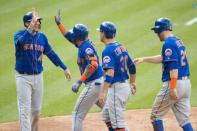 Aug 16, 2018; Philadelphia, PA, USA; New York Mets right fielder Jose Bautista (11) is greeted at home plate by left fielder Michael Conforto (30) and third baseman Wilmer Flores (4) and third baseman Todd Frazier (21) after hitting a grand slam during the fifth inning Philadelphia Phillies at Citizens Bank Park. Bill Streicher-USA TODAY Sports