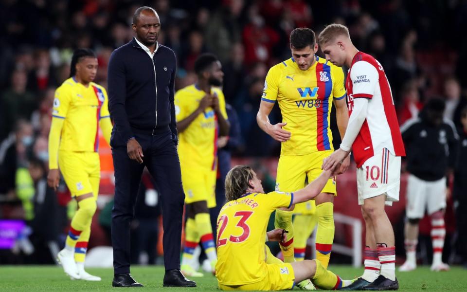 Crystal Palace manager Patrick Vieira looks dejected after the match as Arsenal's Emile Smith Rowe helps Crystal Palace's Conor Gallagher - Action Images via Reuters