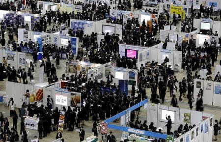 FILE PHOTO: Job seekers attend a job fair held for fresh graduates in Tokyo, Japan, March 20, 2016. REUTERS/Yuya Shino/File Photo