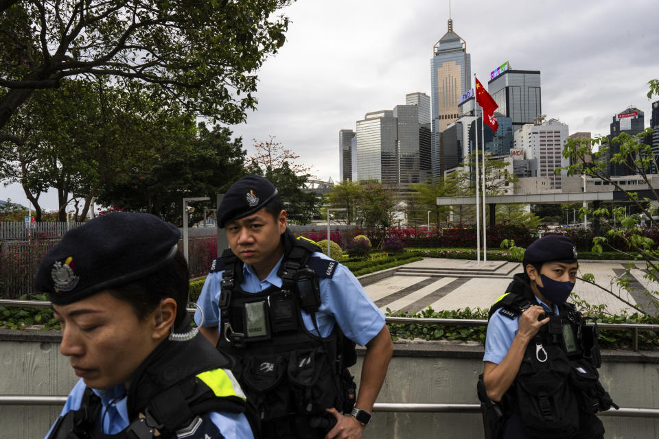 Police officers stand guard outside the Legislative Council as Basic Law Article 23 nears vote in Hong Kong, Tuesday, March 19, 2024. (AP Photo/Louise Delmotte)