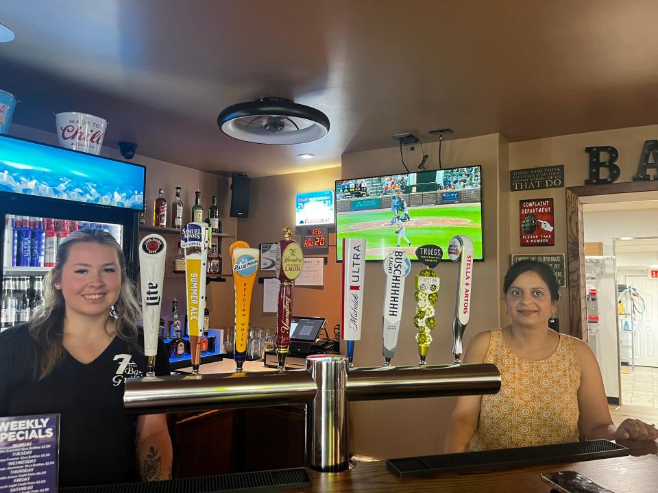 Bartender Caitlin Donnachie (Left) and Nidhi Soin at the bar of 7th Street Bar & Grill.