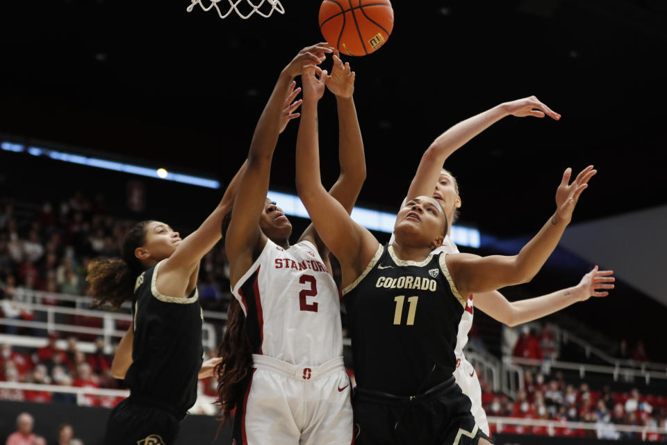 Stanford guard Agnes Emma-Nnopu (2) and Colorado center Quay Miller (11) battle for a rebound during the first quarter of an NCAA college basketball game in Stanford, Calif., Sunday, Jan. 22, 2023. (AP Photo/Jim Gensheimer)