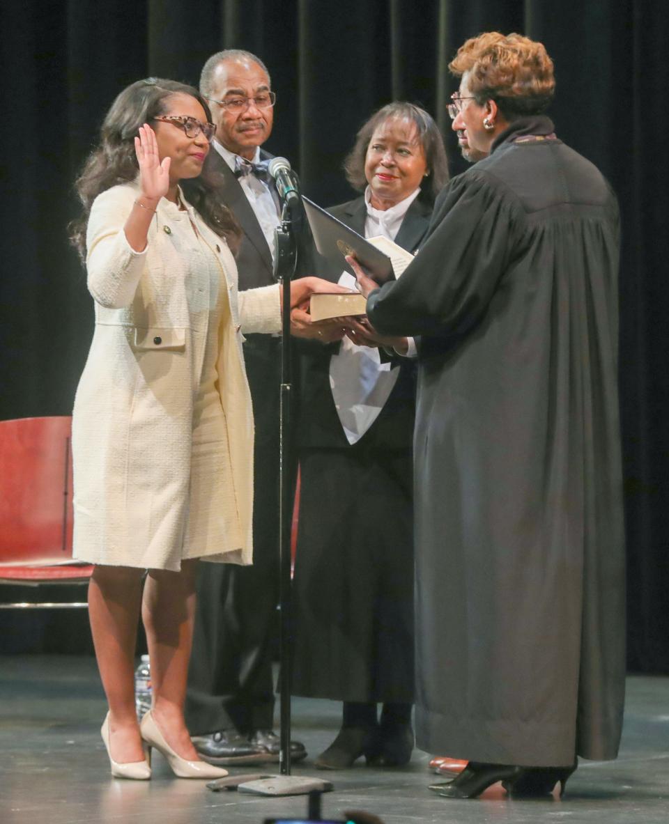 Emilia Sykes is sworn in by Ohio Supreme Court Justice Melody Stewart to serve the 13 U.S. Congressional District of Ohio as her parents, Vernon and Barbara Sykes, look on Saturday in Akron.