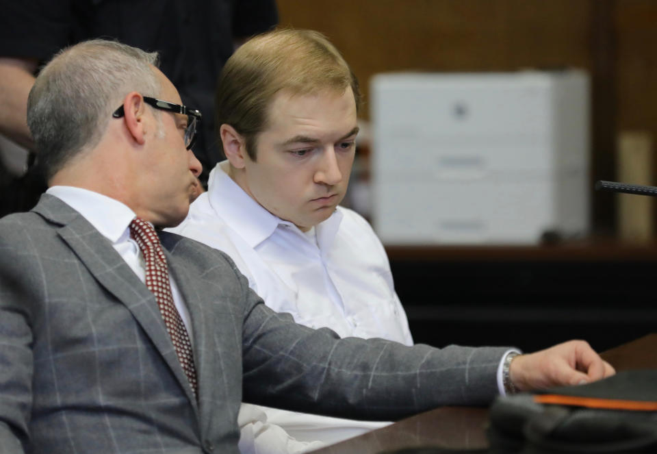 James Jackson, right, confers with his lawyer during a hearing in criminal court, Wednesday Jan. 23, 2019 in New York. Jackson, a white supremacist, pled guilty Wednesday, to killing a black man with a sword as part of a racist plot that prosecutors described as a hate crime. He faces life in prison when he is sentenced on Feb. 13. (AP Photo/Bebeto Matthews)