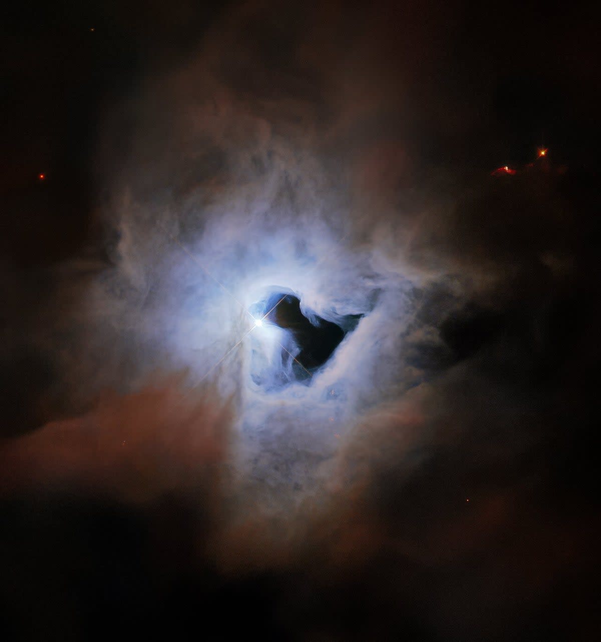 The reflection nebular NGC 1999 lies about 1,350 light years from Earth in the constellation Orion, and exhibits an inky black central “keyhole” in this image taken by the Hubble Space Telescope (ESA/Hubble & NASA, K. Noll)