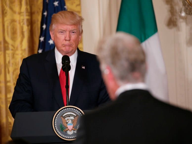 U.S. President Donald Trump (L) listens to a question during a joint news conference with Italian Prime Minister Paolo Gentiloni at the White House in Washington, U.S., April 20, 2017. REUTERS/Kevin Lamarque