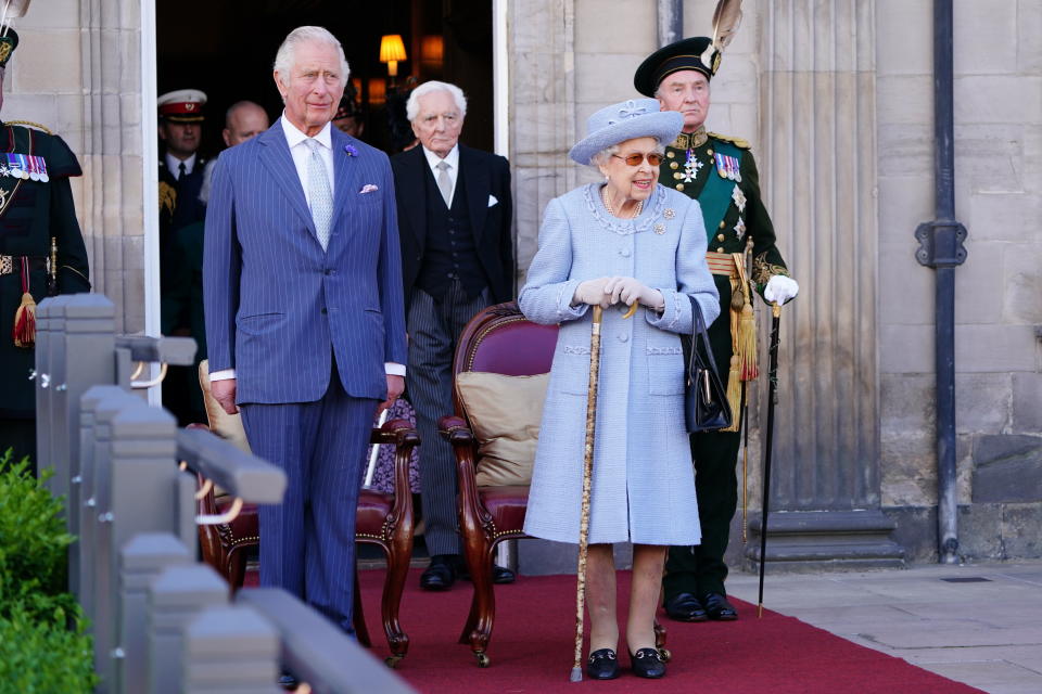 The Prince of Wales, known as the Duke of Rothesay when in Scotland and Queen Elizabeth II attending the Queen's Body Guard for Scotland (also known as the Royal Company of Archers) Reddendo Parade in the gardens of the Palace of Holyroodhouse, Edinburgh. Picture date: Thursday June 30, 2022.