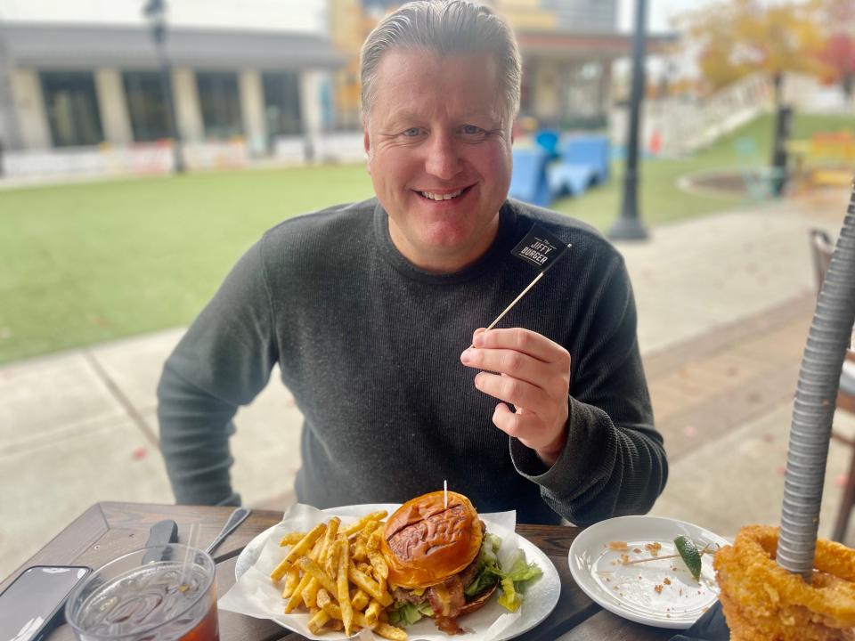 Sports radio host JMV tried the John Michael Vincent Jiffy Burger, which is named after him at Ford's Garage in Noblesville for the first time Oct. 25, 2023. He was pleasantly surprised that peanut butter tasted so good on a piece of meat.