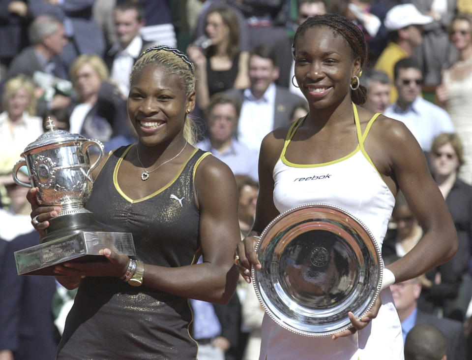 FILE - In this June 8, 2002, file photo, Serena Williams, left, and her sister Venus hold their trophies after the women's final of the French Open tennis tournament at Roland Garros stadium in Paris. Serena won 7-5, 6-3. Neither Williams sister is entered in this year’s tournament at Roland Garros. (AP Photo/Francois Mori, File)